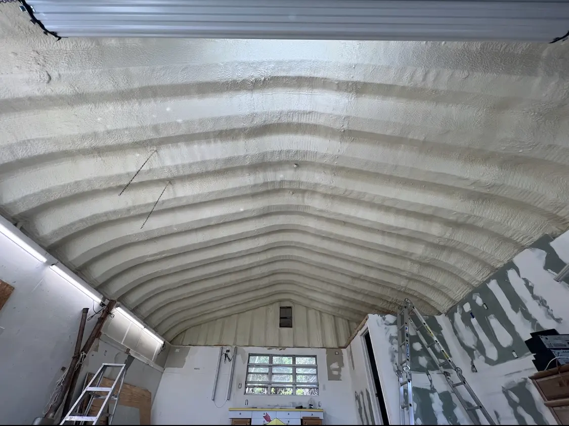Spray polyurethane foam applied to the underside of a metal roof deck in Longswamp